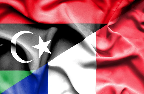 Mávání vlajkou Francie a Libye — Stock fotografie