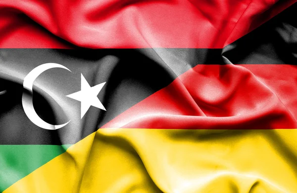 Wapperende vlag van Duitsland en Libië — Stockfoto