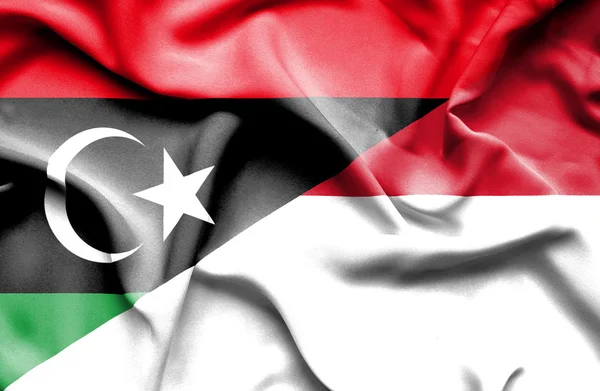 Waving flag of Monaco and Libya — Stock Photo, Image