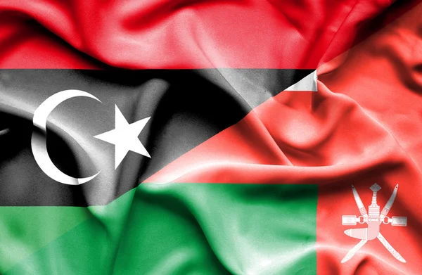 Waving flag of Oman and Libya — Stock Photo, Image