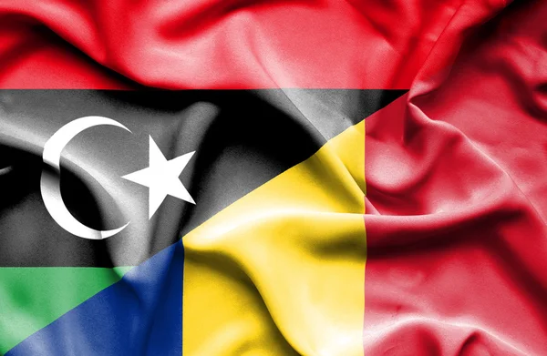 Waving flag of Romania and Libya — Stock Photo, Image