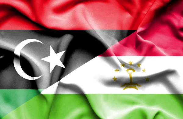 Waving flag of Tajikistan and Libya — Stock Photo, Image