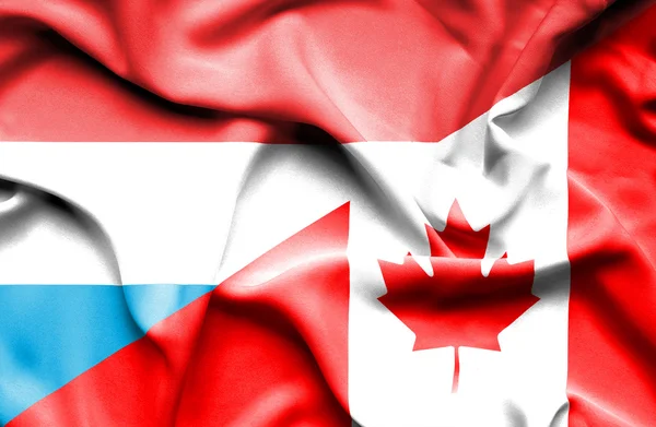 Waving flag of Canada and Luxembourg — Stock Photo, Image