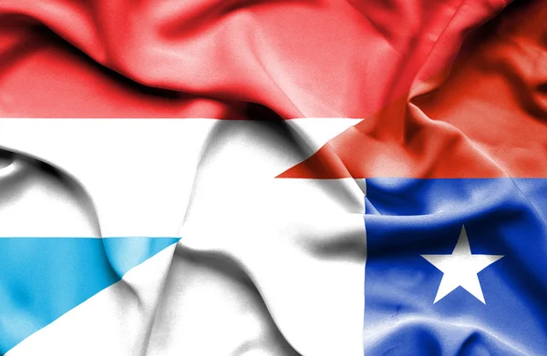Waving flag of Chile and Luxembourg — Stock Photo, Image