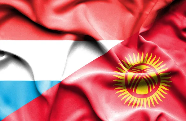 Waving flag of Kyrgyzstan and Luxembourg — Stock Photo, Image