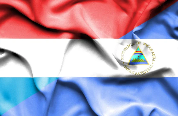 Waving flag of Nicaragua and Luxembourg — Stock Photo, Image