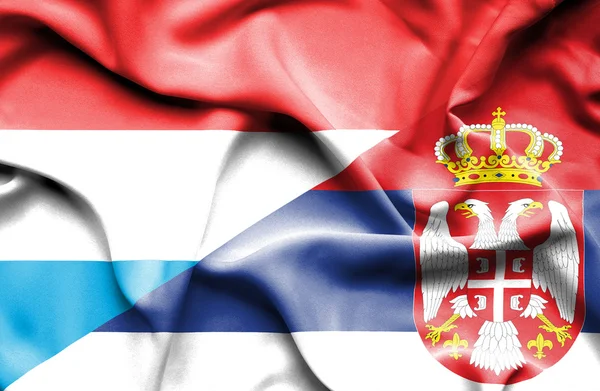 Waving flag of Serbia and Luxembourg — Stock Photo, Image