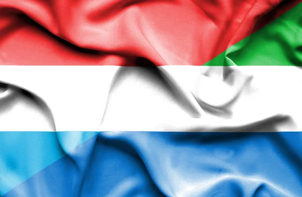 Waving flag of Sierra Leone and Luxembourg — Stock Photo, Image