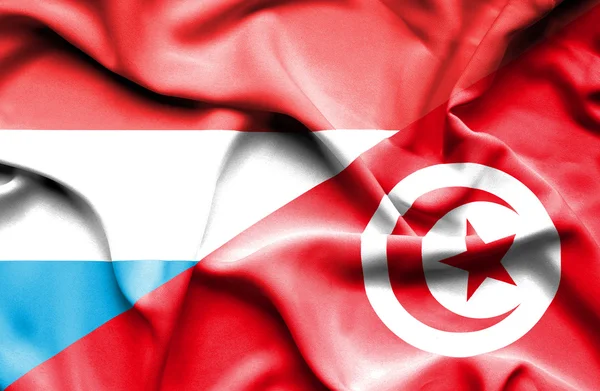 Waving flag of Tunisia and Luxembourg — Stock Photo, Image