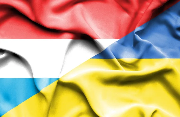 Waving flag of Ukraine and Luxembourg — Stock Photo, Image