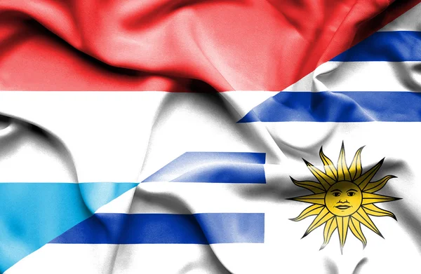 Waving flag of Uruguay and Luxembourg — Stock Photo, Image