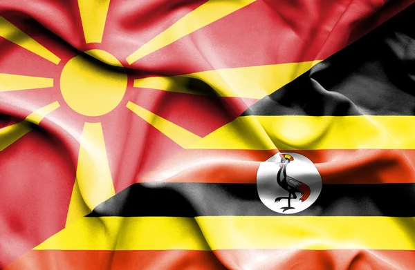 Flagge Ugandas und Mazedoniens schwenken — Stockfoto