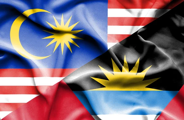 Waving flag of Antigua and Barbuda and Malaysia — Stock Photo, Image