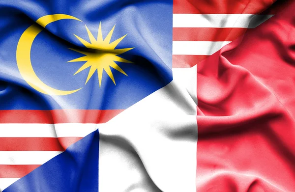 Waving flag of France and Malaysia — Stock Photo, Image