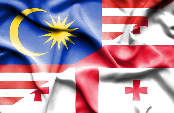 Macha flagą Gruzji i Malezji — Zdjęcie stockowe