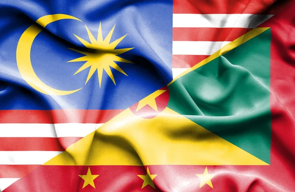 건지와 말레이시아의 국기를 흔들며 — 스톡 사진