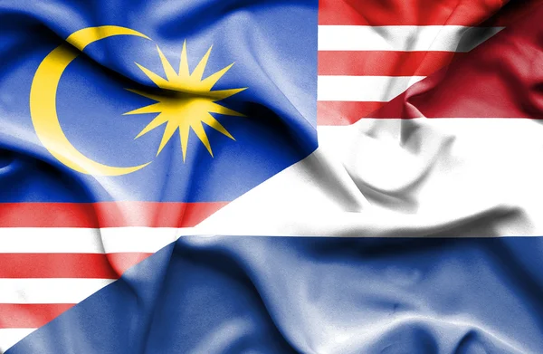 Bandeira ondulada dos Países Baixos e da Malásia — Fotografia de Stock