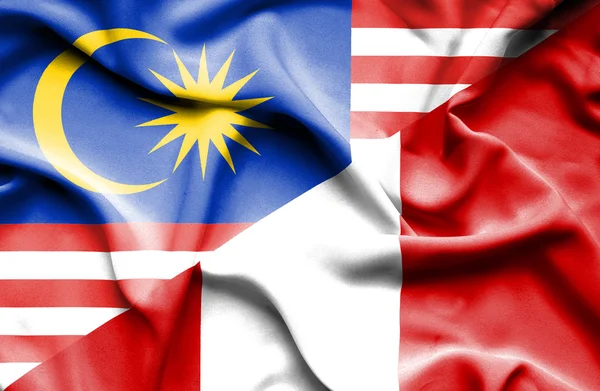 Waving flag of Peru and Malaysia — Stock Photo, Image