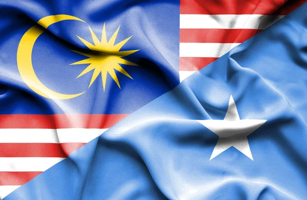 Waving flag of Somalia and Malaysia — Stock Photo, Image