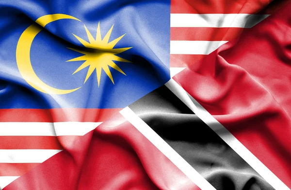 Waving flag of Trinidad and Tobago and Malaysia — Stock Photo, Image