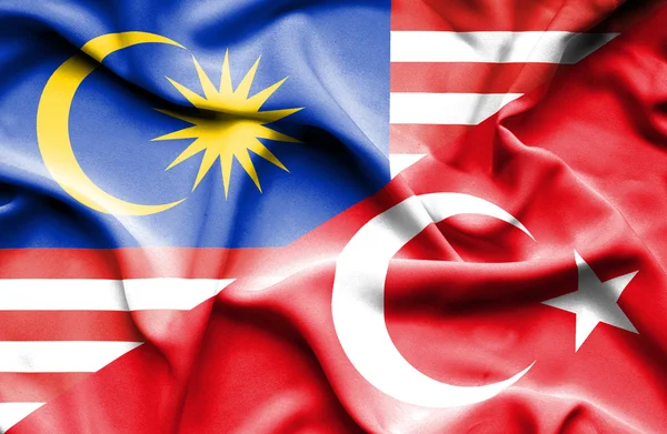 Macha flagą Turcji i Malezji — Zdjęcie stockowe