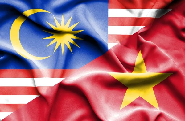 Waving flag of Vietnam and Malaysia — Stock Photo, Image