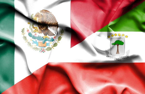Macha flagą poprzecznego Giuinea i Meksyku — Zdjęcie stockowe