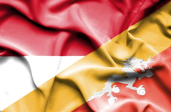 Flagge von Bhutan und Monaco schwenken — Stockfoto