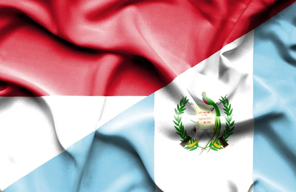 Waving flag of Guatemala and Monaco — Stock Photo, Image