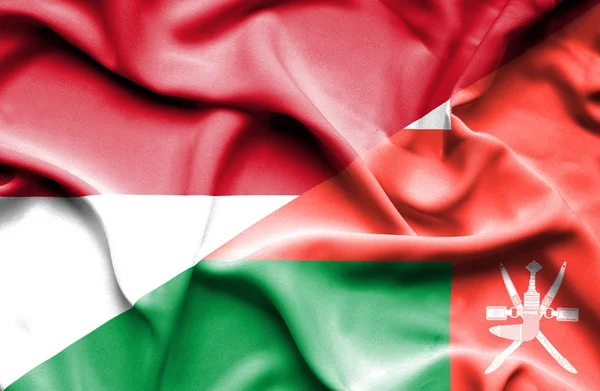 Waving flag of Oman and Monaco — Stock Photo, Image