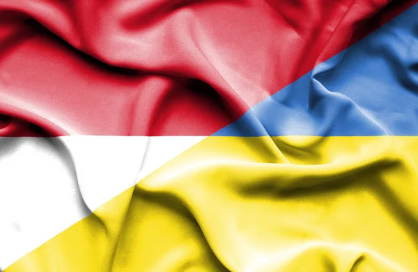 Vlající vlajka Ukrajiny a Monako — Stock fotografie