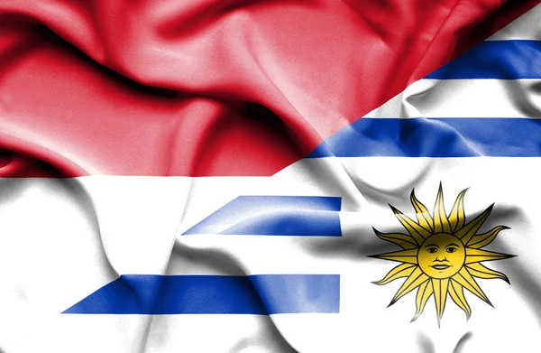 Waving flag of Uruguay and Monaco — Stock Photo, Image