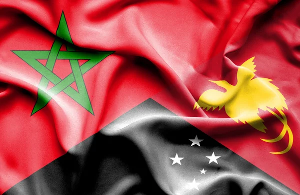 Wapperende vlag van Papoea-Nieuw-Guinea en Marokko — Stockfoto