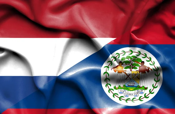 Integetett a Belize-ből és Hollandia zászlaja — Stock Fotó