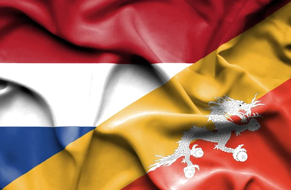 Waving flag of Bhutan and Netherlands — Stock Photo, Image