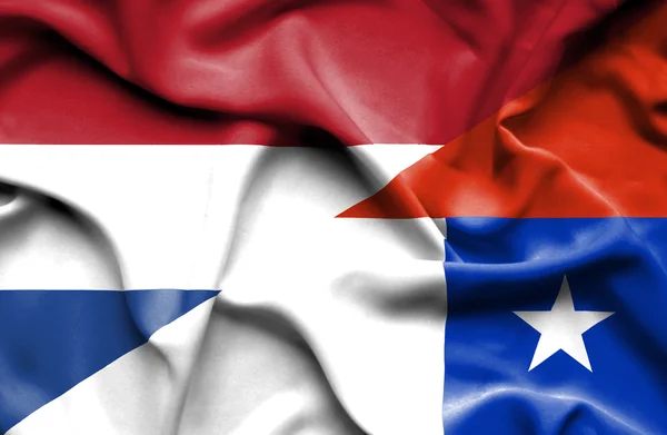 Waving flag of Chile and Netherlands — Stock Photo, Image