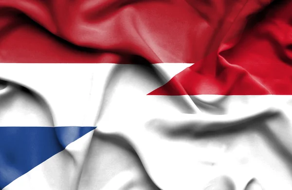 Flagge von Indonesien und den Niederlanden schwenken — Stockfoto