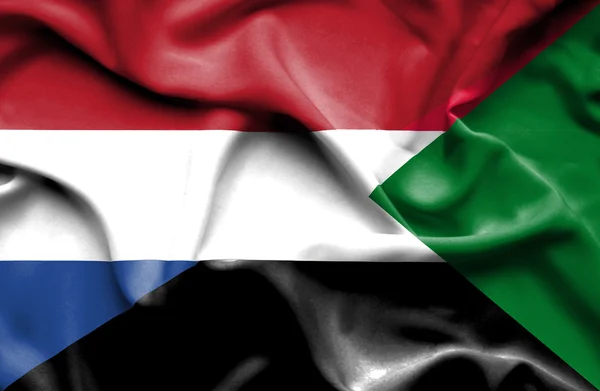 Flagge des Sudan und der Niederlande schwenken — Stockfoto