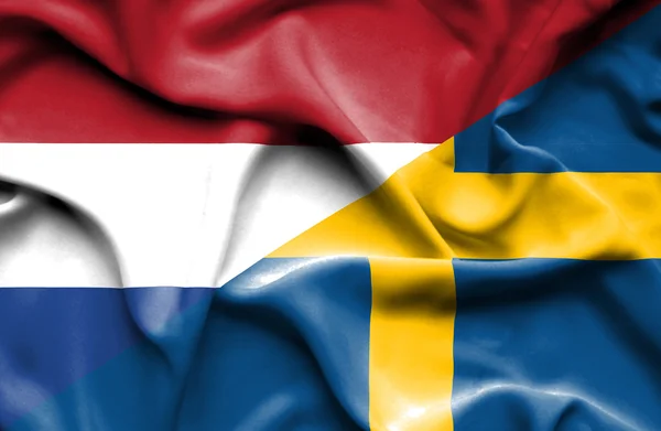 Waving flag of Sweden and Netherlands — Stock Photo, Image