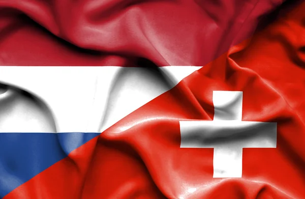 Bandeira ondulada da Suíça e Países Baixos — Fotografia de Stock