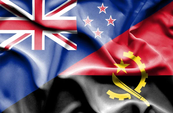 Waving flag of Angola and New Zealand — Stock Photo, Image