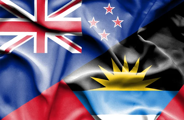 Waving flag of Antigua and Barbuda and New Zealand — Stock Photo, Image
