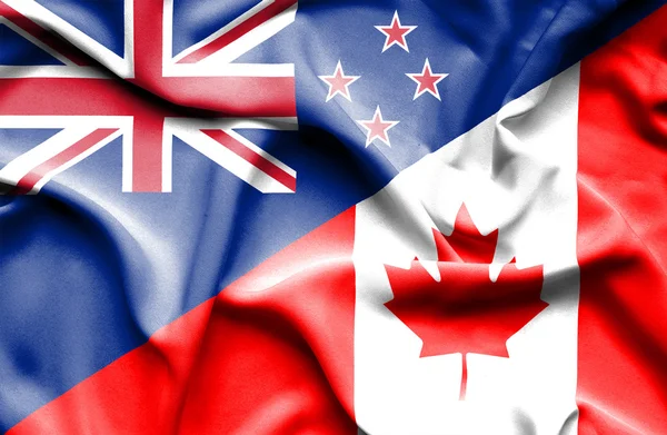 Waving flag of Canada and New Zealand — Stock Photo, Image