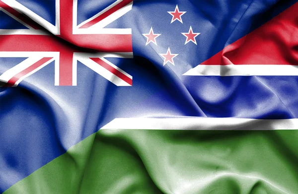 Wapperende vlag van gambia en Nieuw-Zeeland — Stockfoto