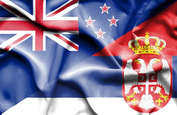 Waving flag of Serbia and New Zealand — Stock Photo, Image