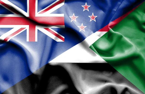 Waving flag of Sudan and New Zealand — Stock Photo, Image