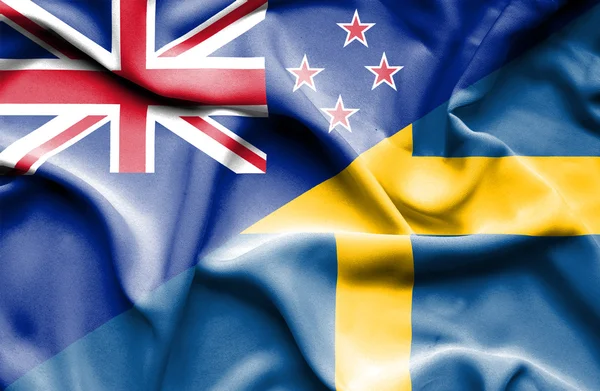 Bandeira ondulada da Suécia e Nova Zelândia — Fotografia de Stock