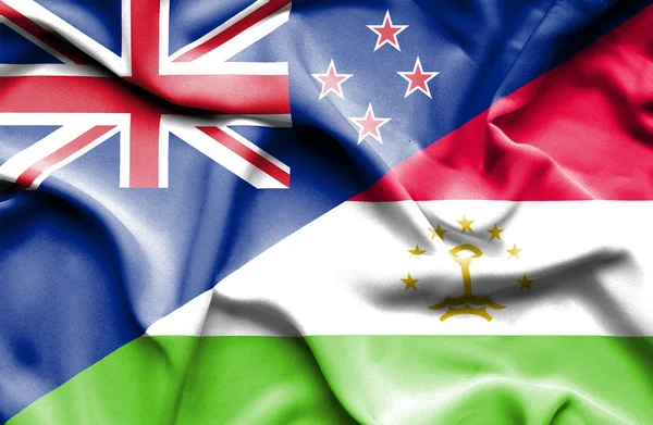 Waving flag of Tajikistan and New Zealand — Stock Photo, Image