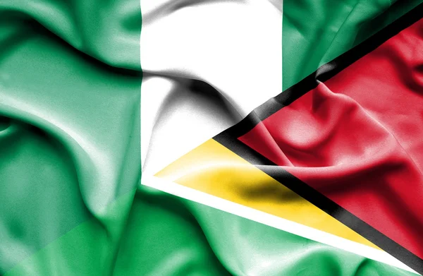 Waving flag of Guyana and Nigeria — Stock Photo, Image