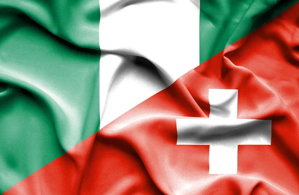 Schweiz och nigeria viftande flagga — Stockfoto